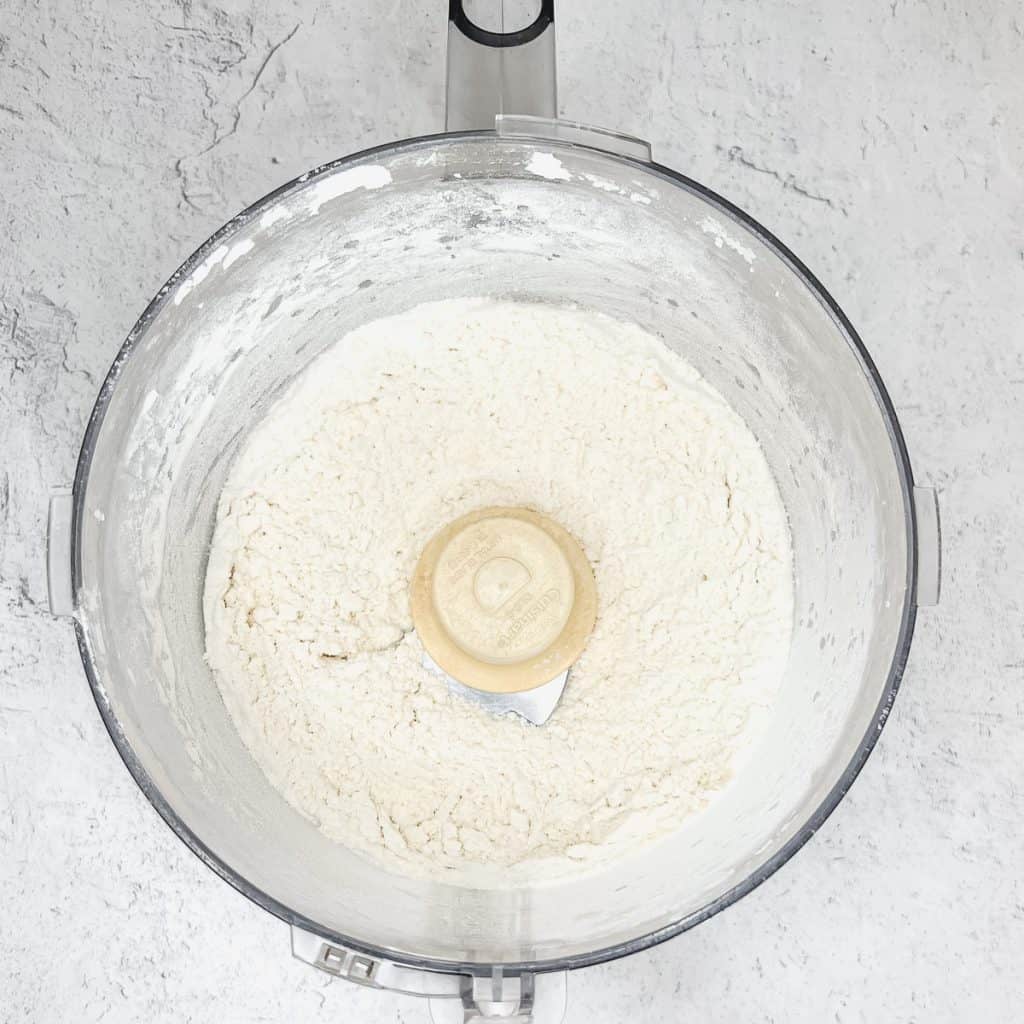 Flour and salt mixed together with butter in a food processor.