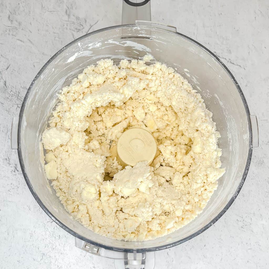 Food processor with Simple Rough Puff Pastry ingredients fully combined.
