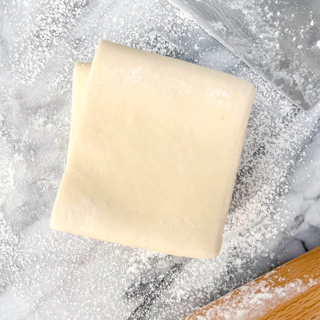 Simple Rough Puff Pastry on a flour dusted marble countertop.